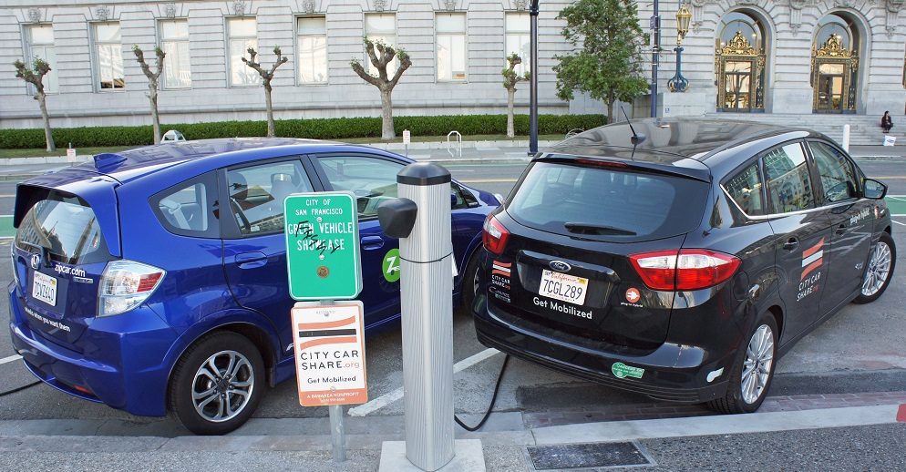 Ford C-Max Energi  and Honda Fit EV at a public charging station